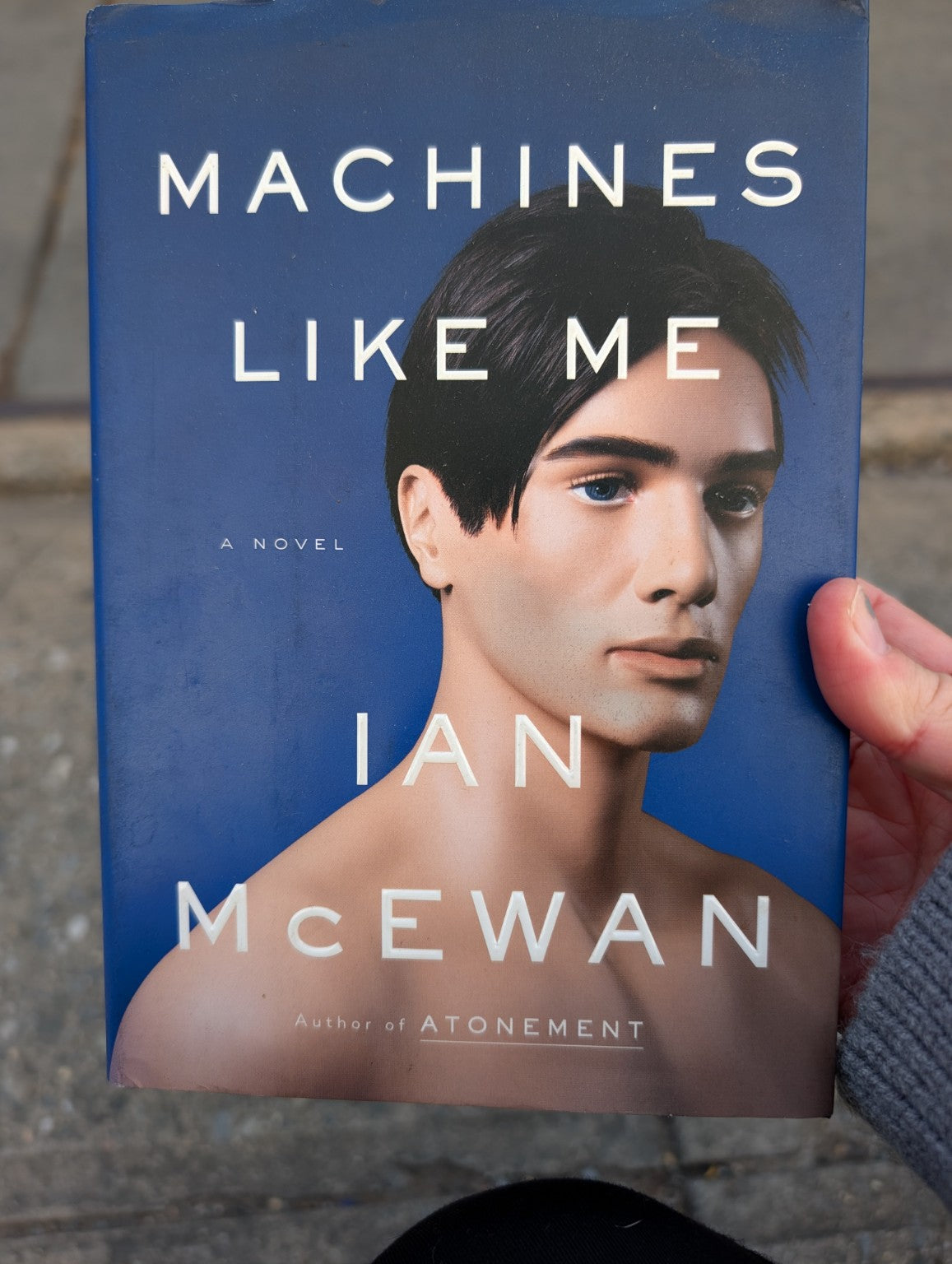 Machines Like Me by Ian McEwan, preowned hardcover front cover with portrait on blue background