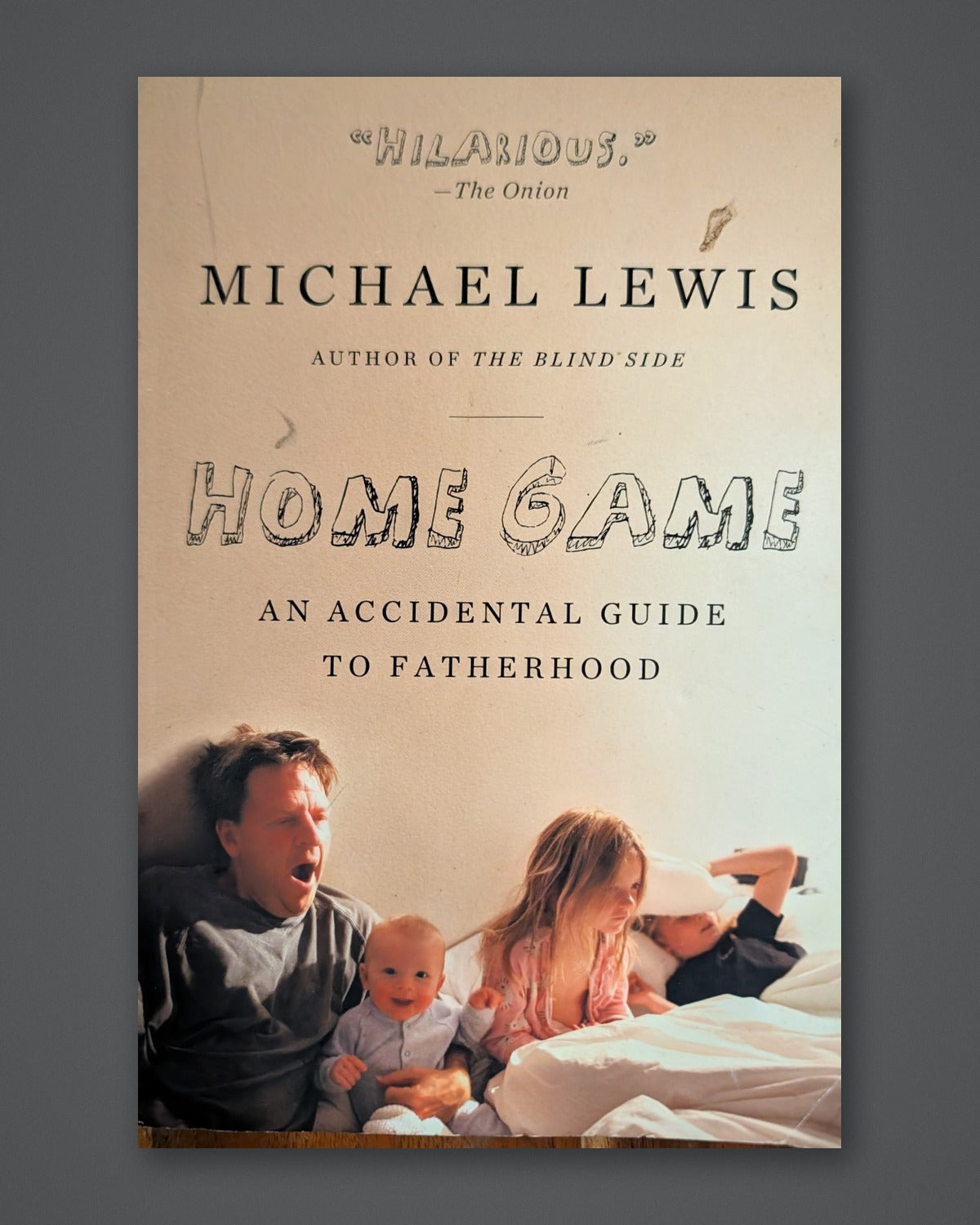Home Game: An Accidental Guide to Fatherhood — photographed copy on Paper + Stone gray slate background