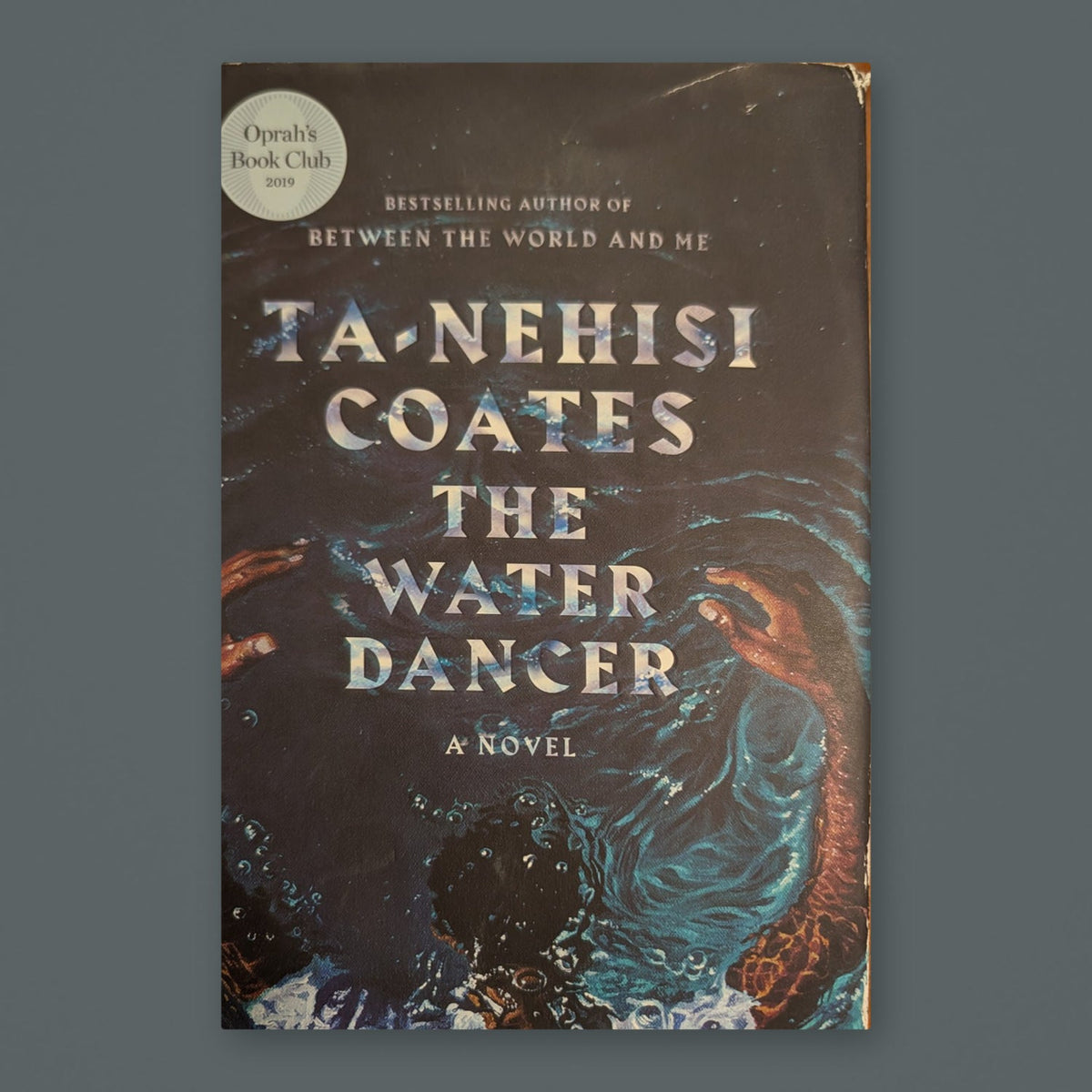 The Water Dancer by Ta-Nehisi Coates — original physical book on gray slate background